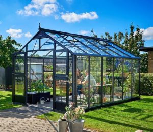 Juliana Premium Greenhouse in a garden setting.