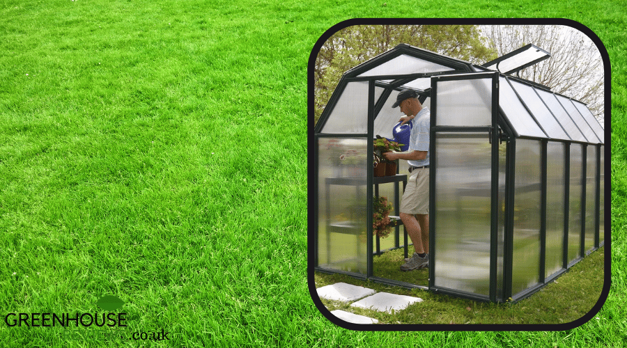 An example of a greenhouse installed onto a grass area in the garden.